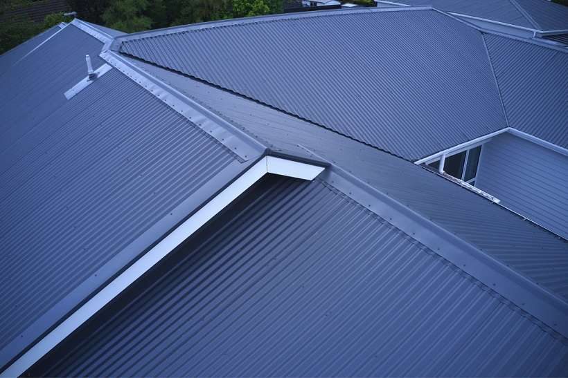 A hipped corrugated metal roof in blue-grey, seen from above